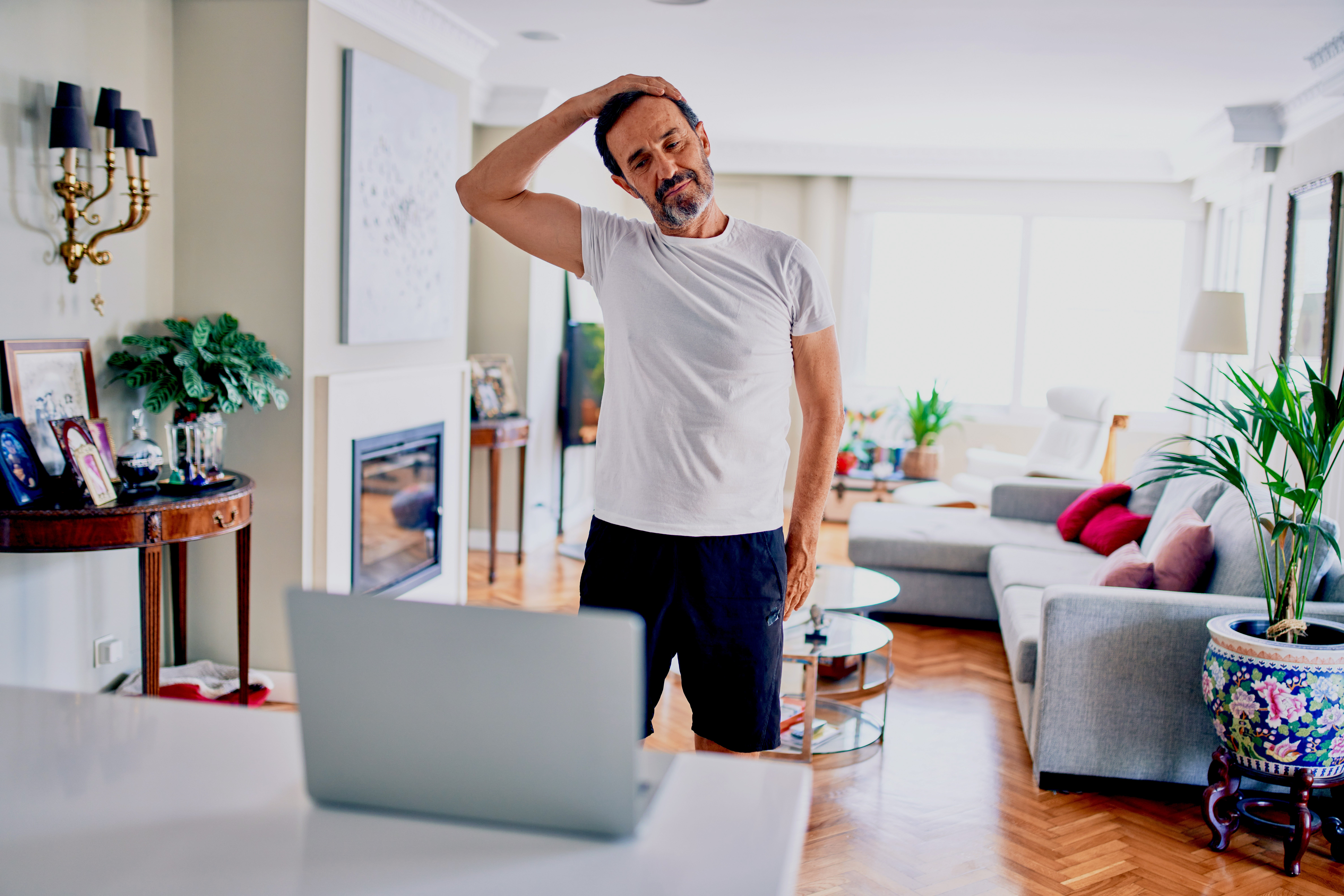 Man doing physiotherapy exercises online.