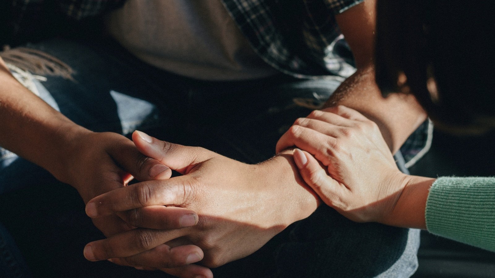 a hand resting on another person's wrist
