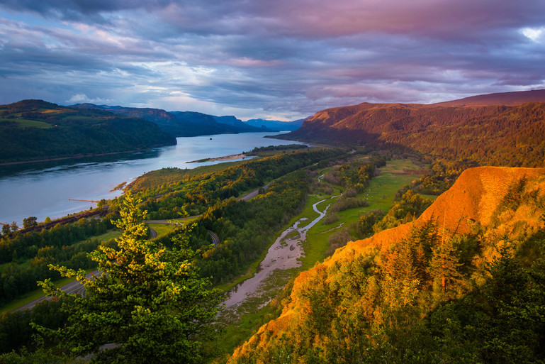 View over a mountain of a river with clouds in the sky