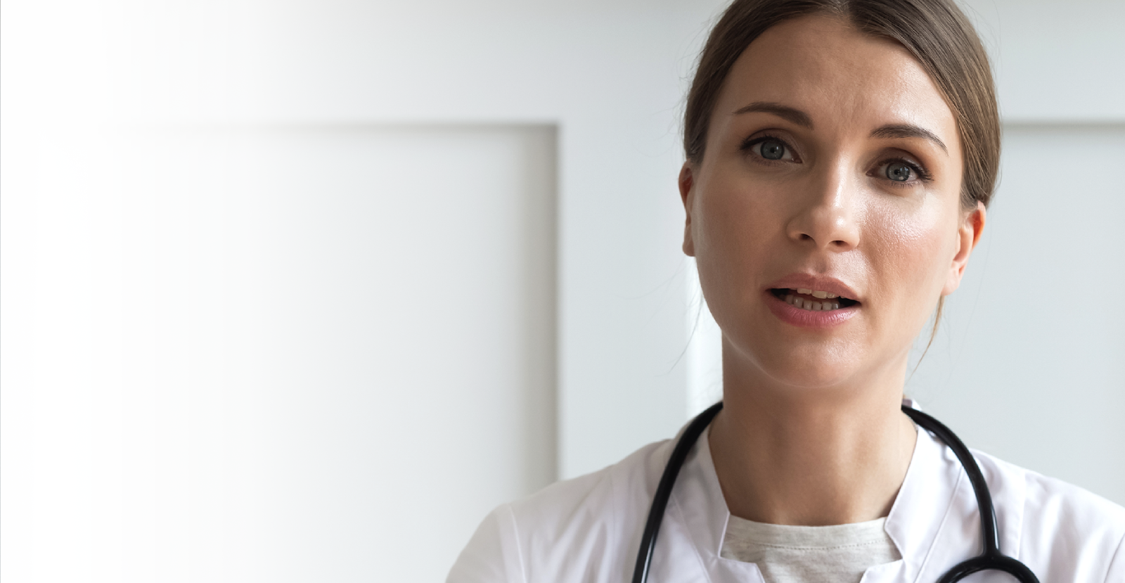 Female doctor looking at lens mid speech 