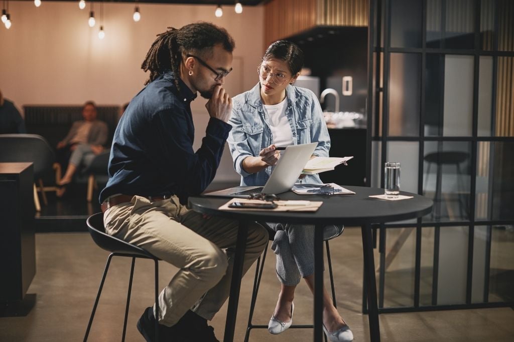 Does your workplace feel comfortable starting a conversation about mental health? Two people in a meeting